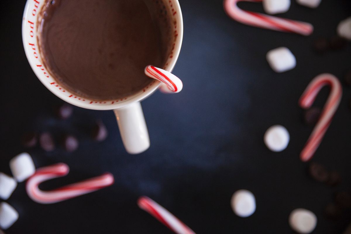 white ceramic mug with chocolate and candy cane