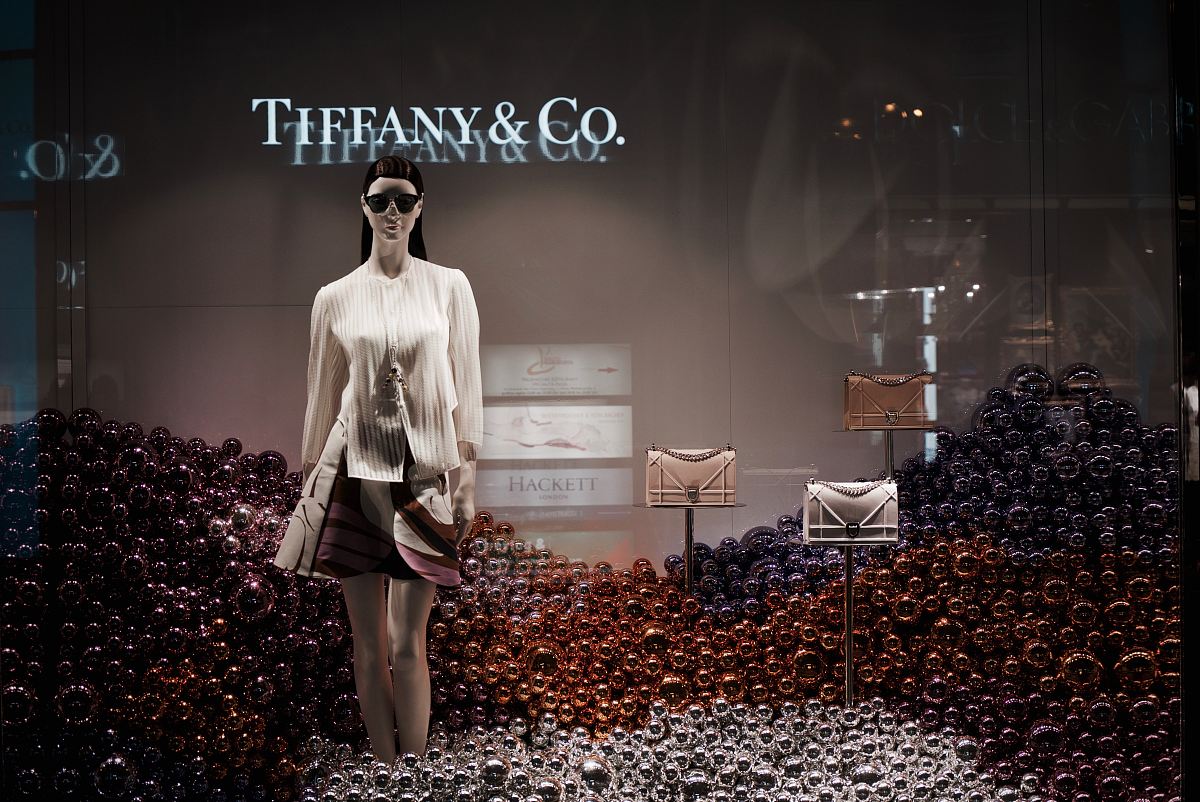 woman standing surrounding assorted-color balls