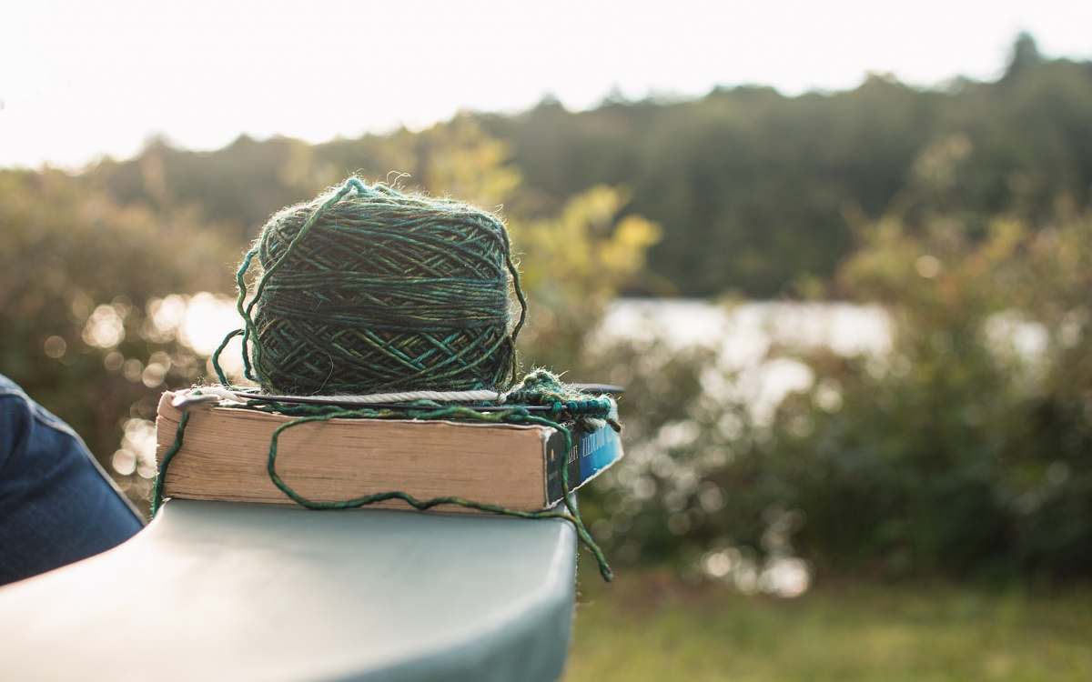 knitting green yard on white book yarn