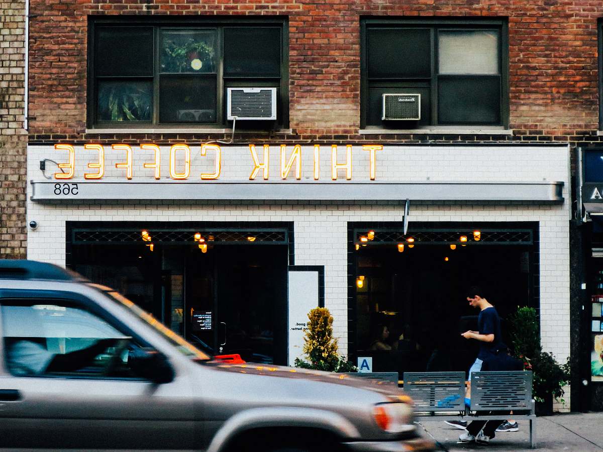 brick gray car at the front of Think Coffee shop car