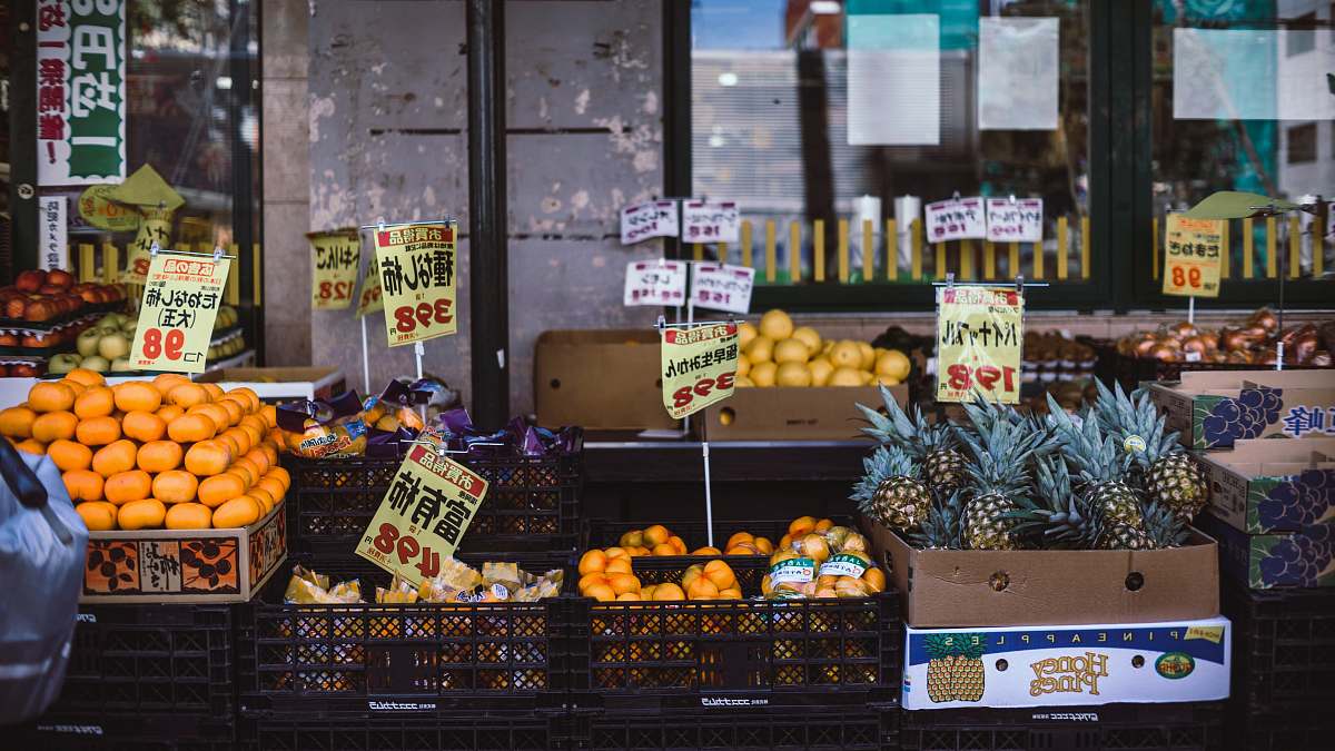 pineapple assorted fruits with labels on crates orange