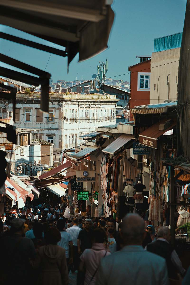 person crowd of people walking on street near buildings during daytime market