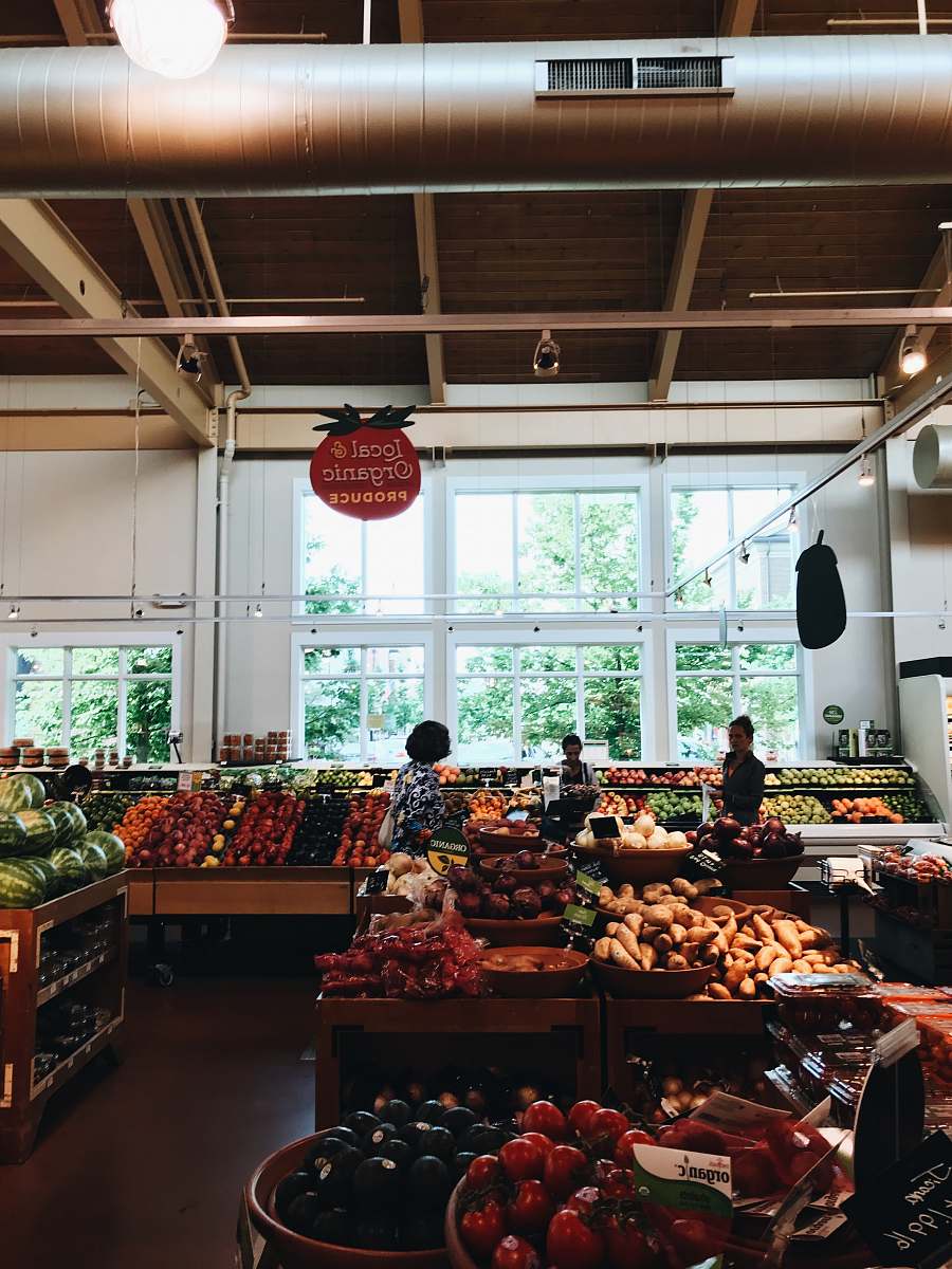 person group of people inside mart at fruit section grocery store