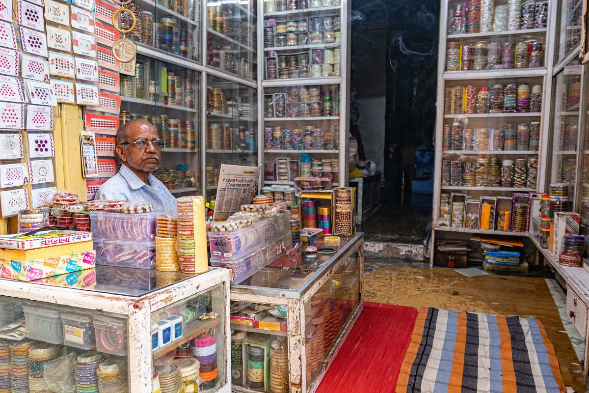 person man holding newspaper shelf