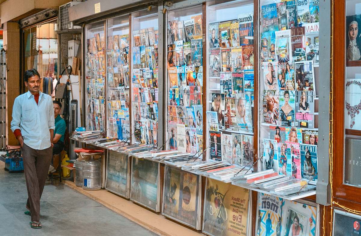person man in white dress shirt newsstand