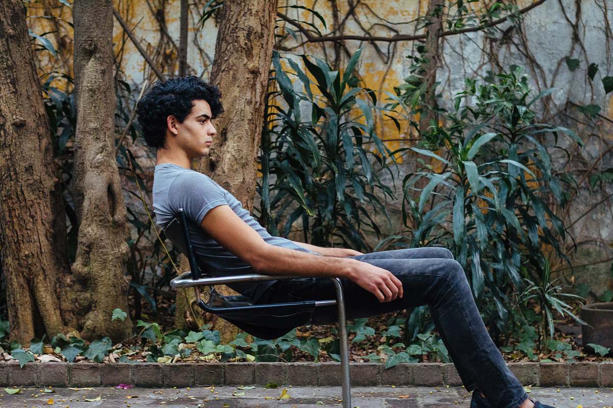 people man sitting on gray steel chair person