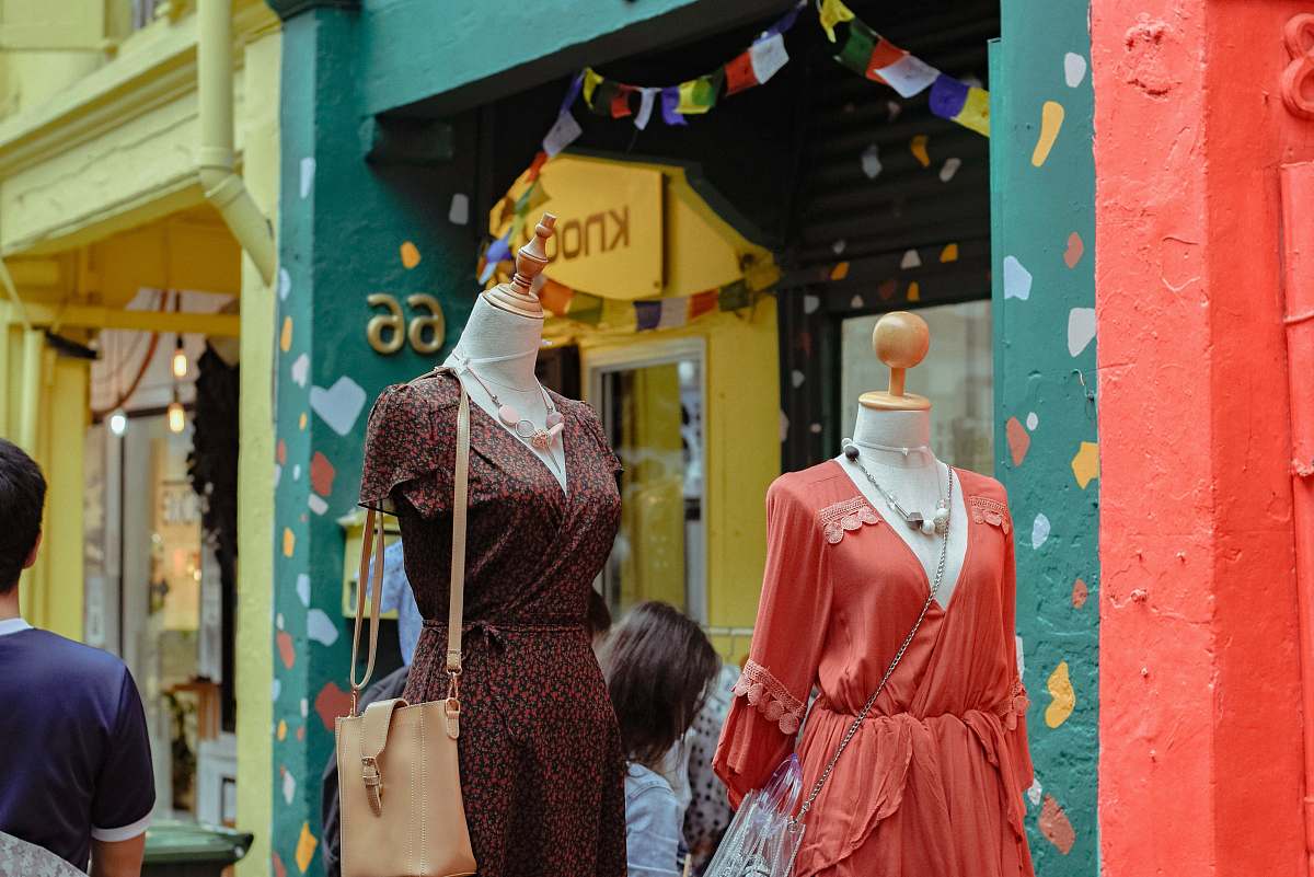 person people standing near dress outdoor during daytime apparel