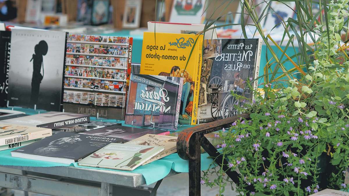 shop posters beside wall newsstand