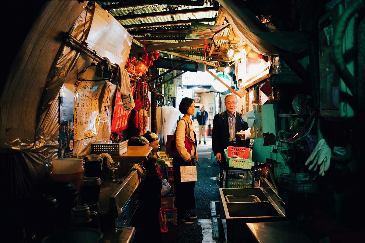 person woman and man standing inside house market