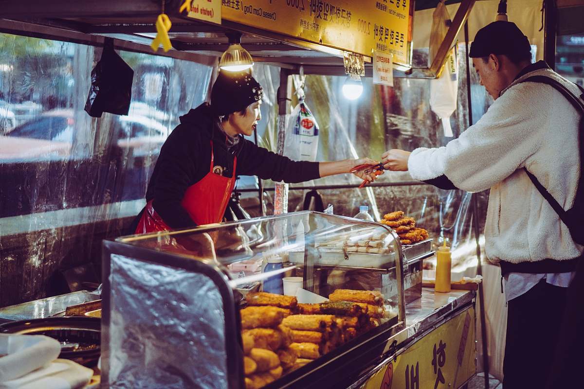 person woman selling food helmet