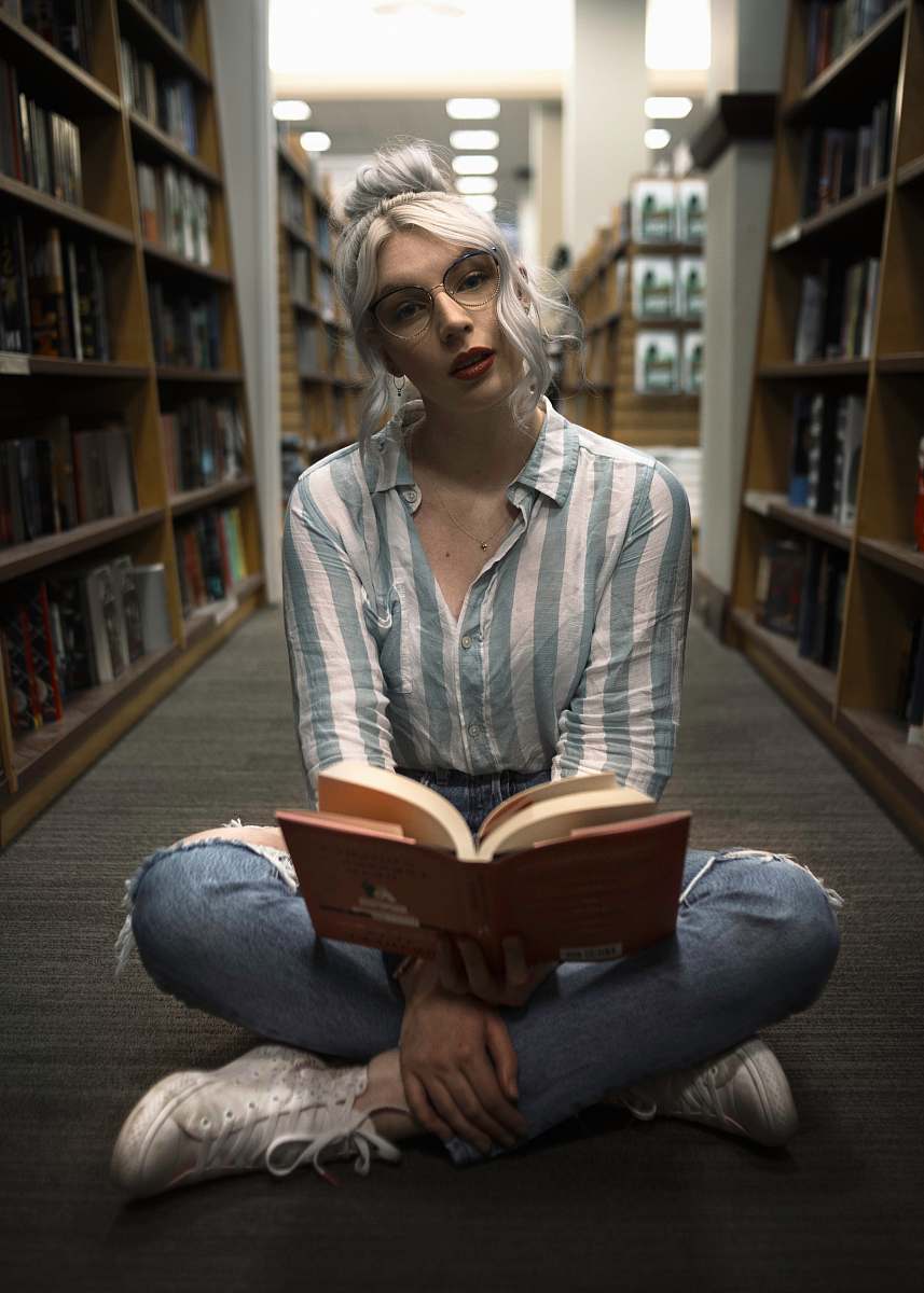 furniture woman sitting near book rack book