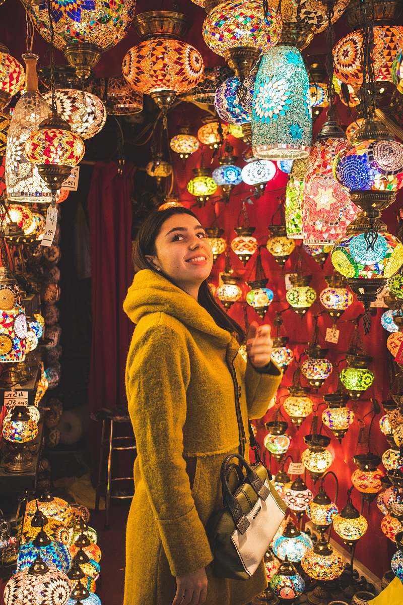 shop woman looking at pendant lamps bazaar