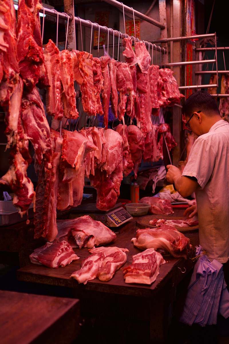 human man chopping meat butcher shop