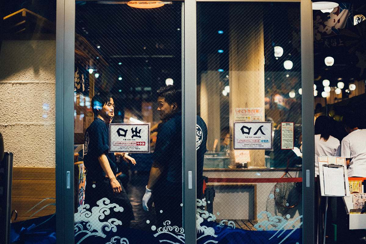 human two man standing near the glass wall people