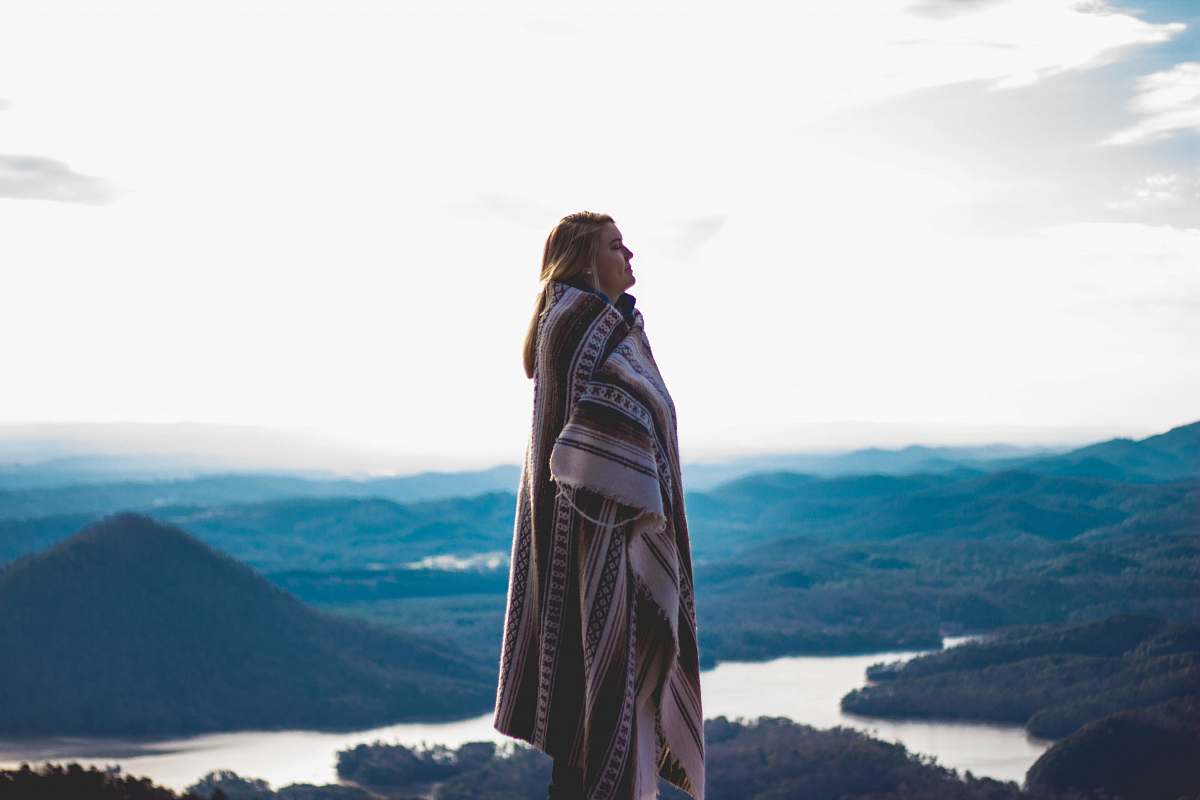 human woman wearing coat standing on cliff people