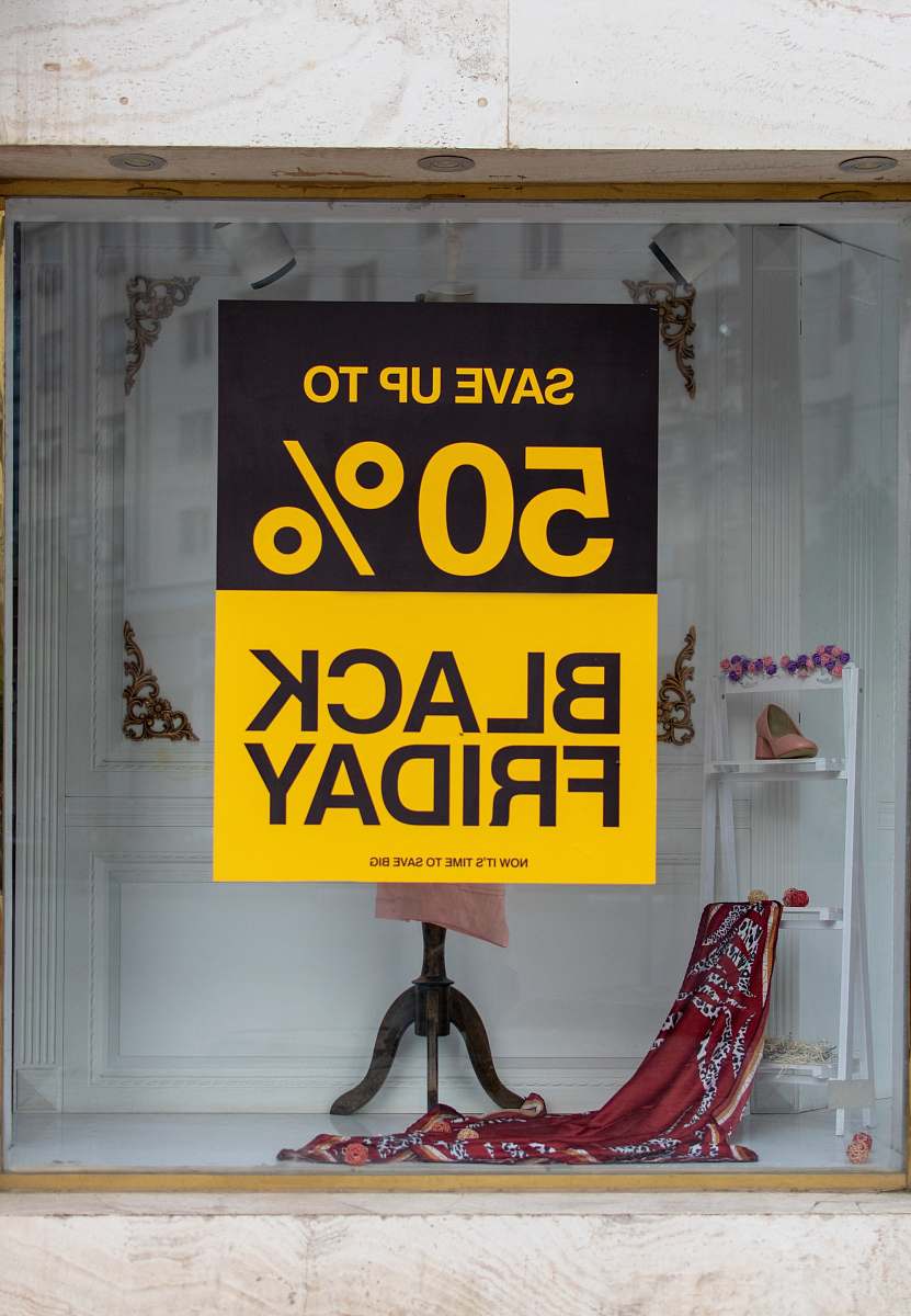 clothing black friday text on red garment background window display