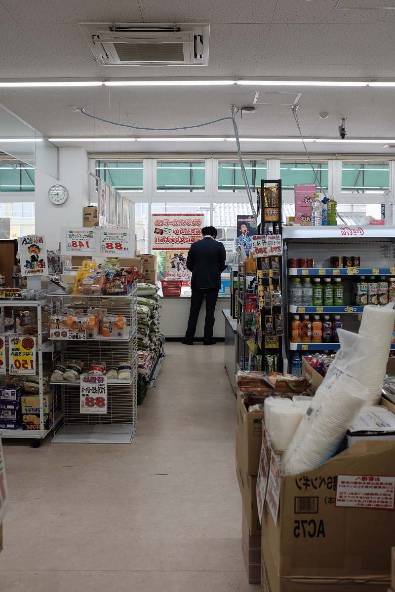 human man standing on store counter during daytime person