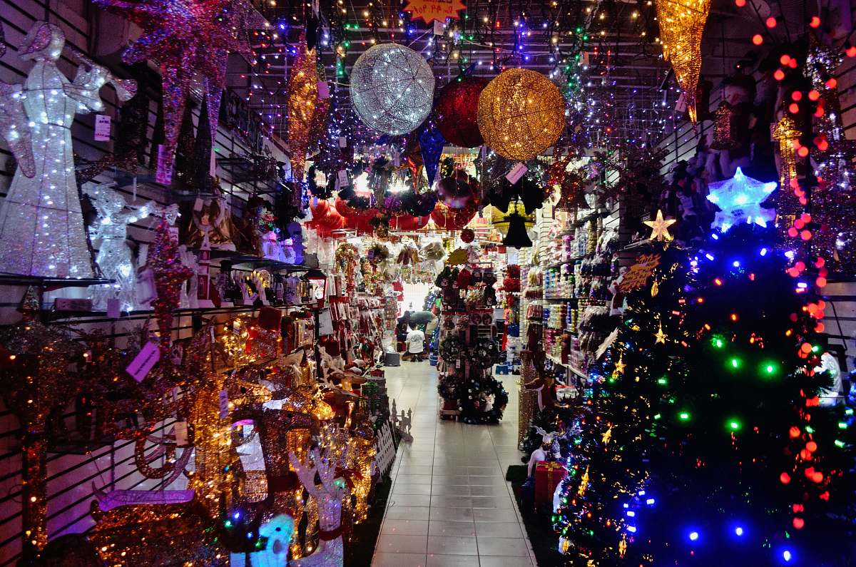 market multicolored string lights beside Christmas tree bazaar