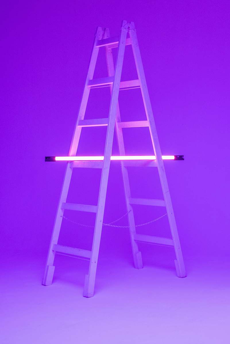 stand turned-on fluorescent lamp on folding ladder chair