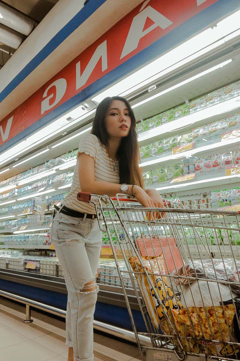 supermarket woman near beverage cooler grocery store