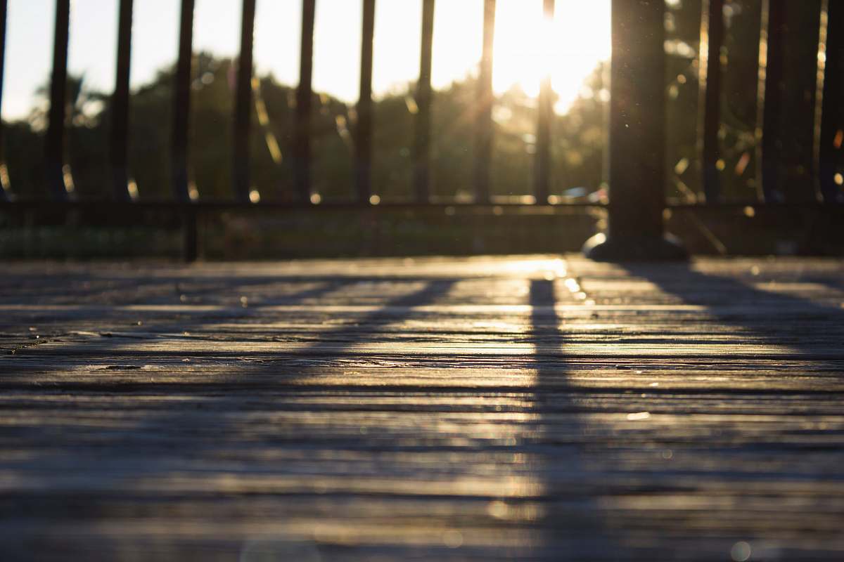 wood black fence against the light sun