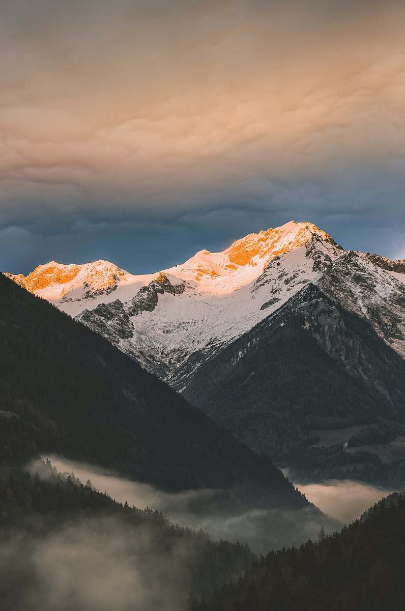nature mountain covered with snow under white skies mountain range
