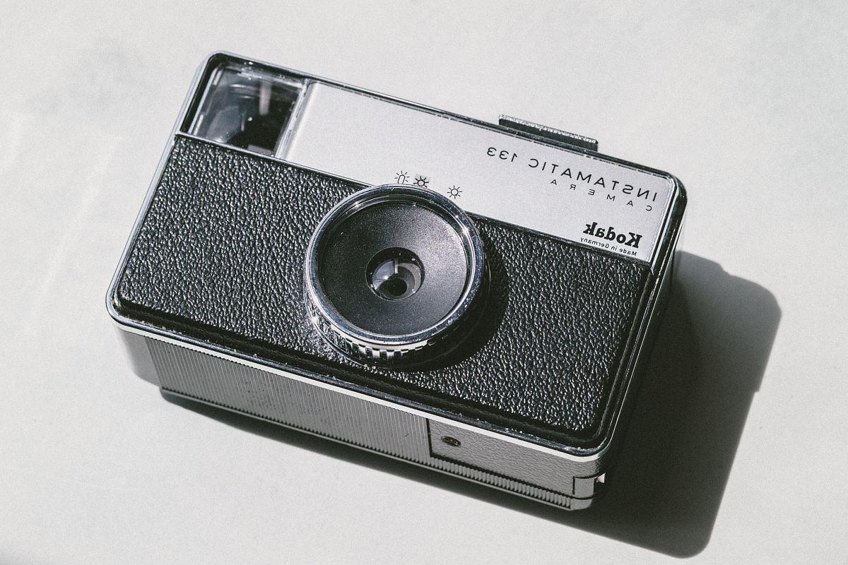 black and gray Kodak camera on white surface
