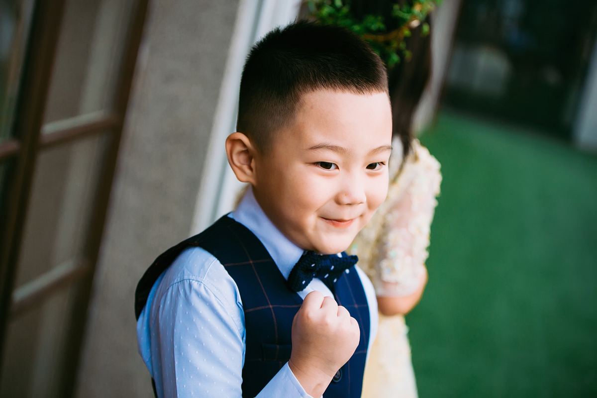 boy wearing blue waistcoat and dress shirt