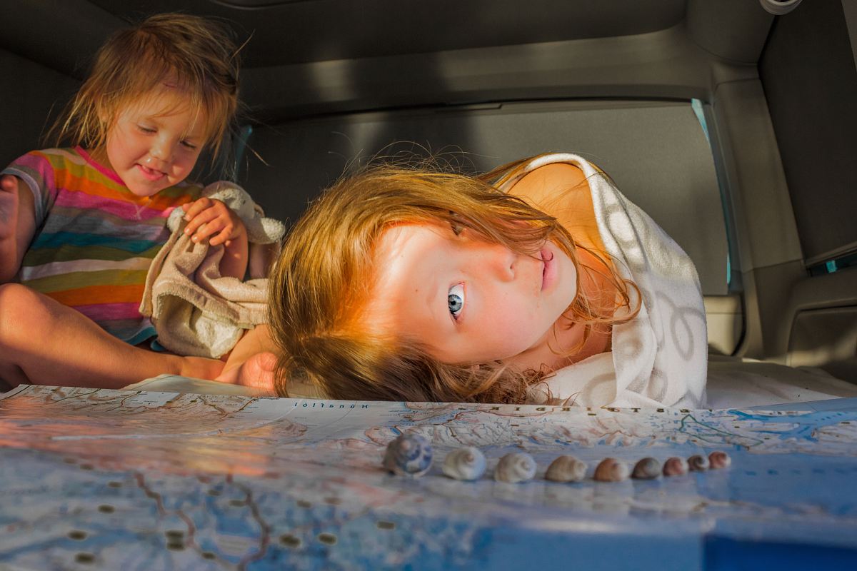 girl lying near gray seashells