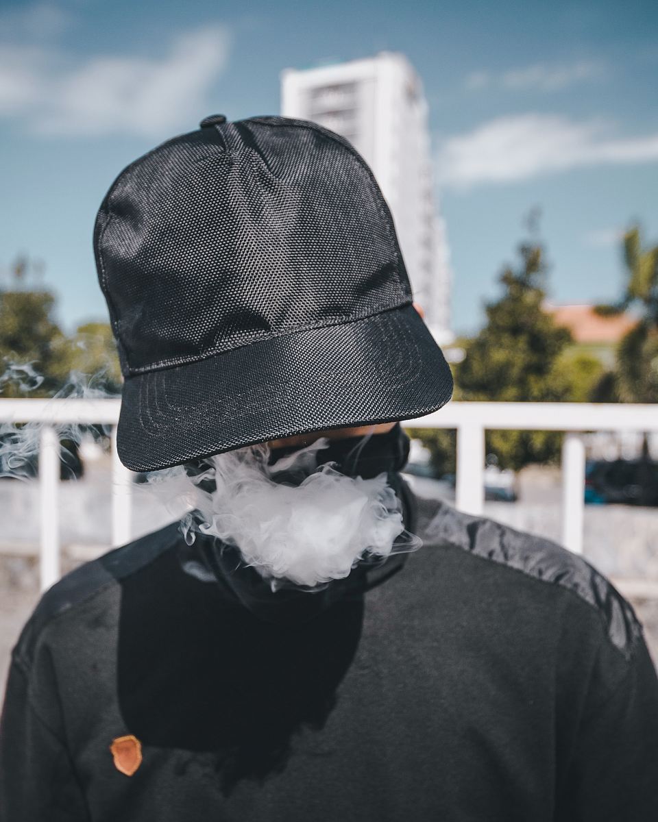 man wearing black cap while taking selfie