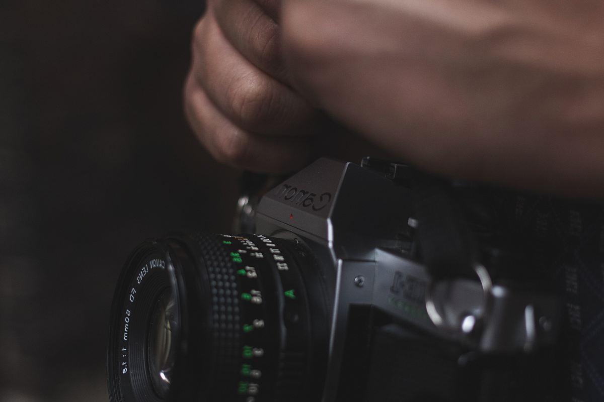 person holding black DSLR camera