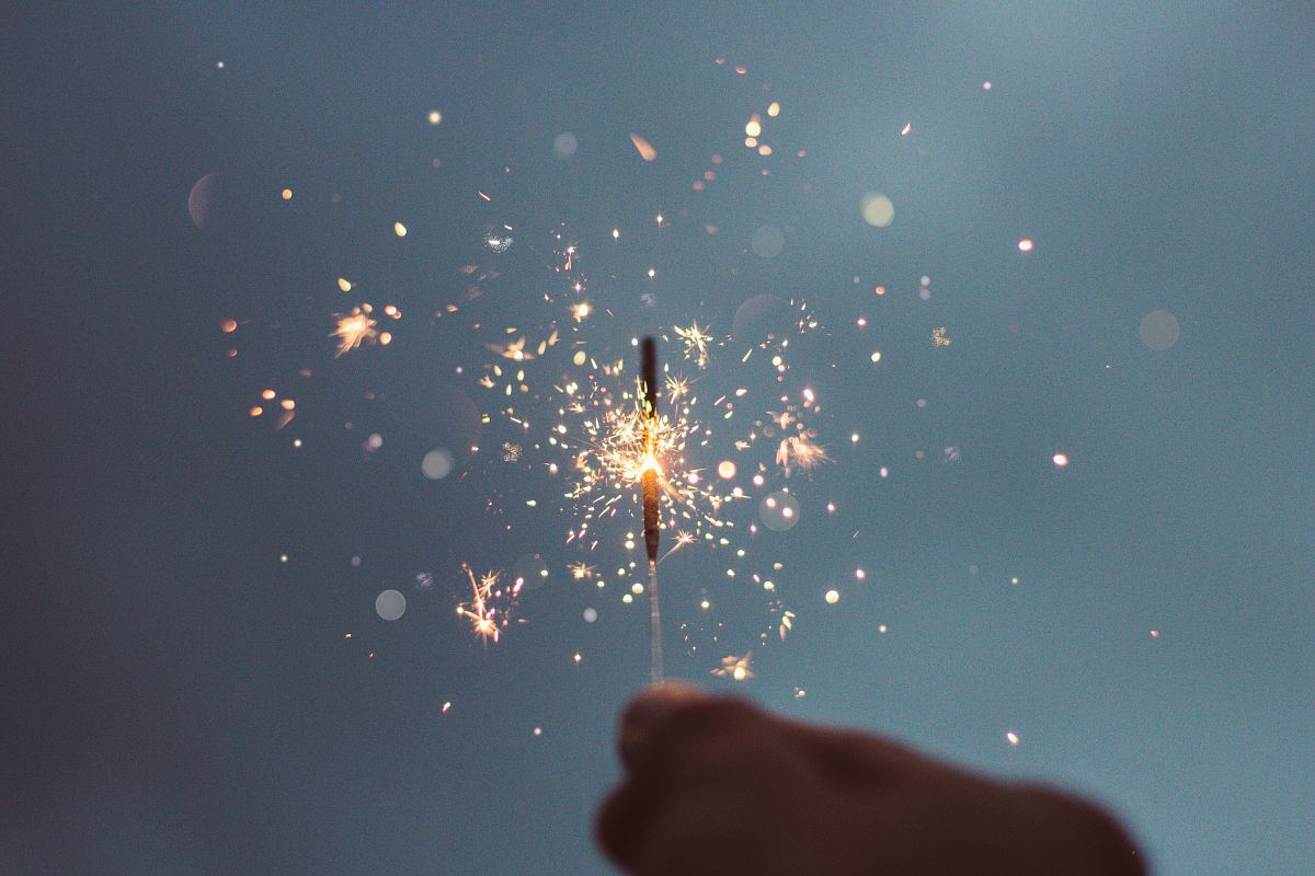 person holding lighted sparklers