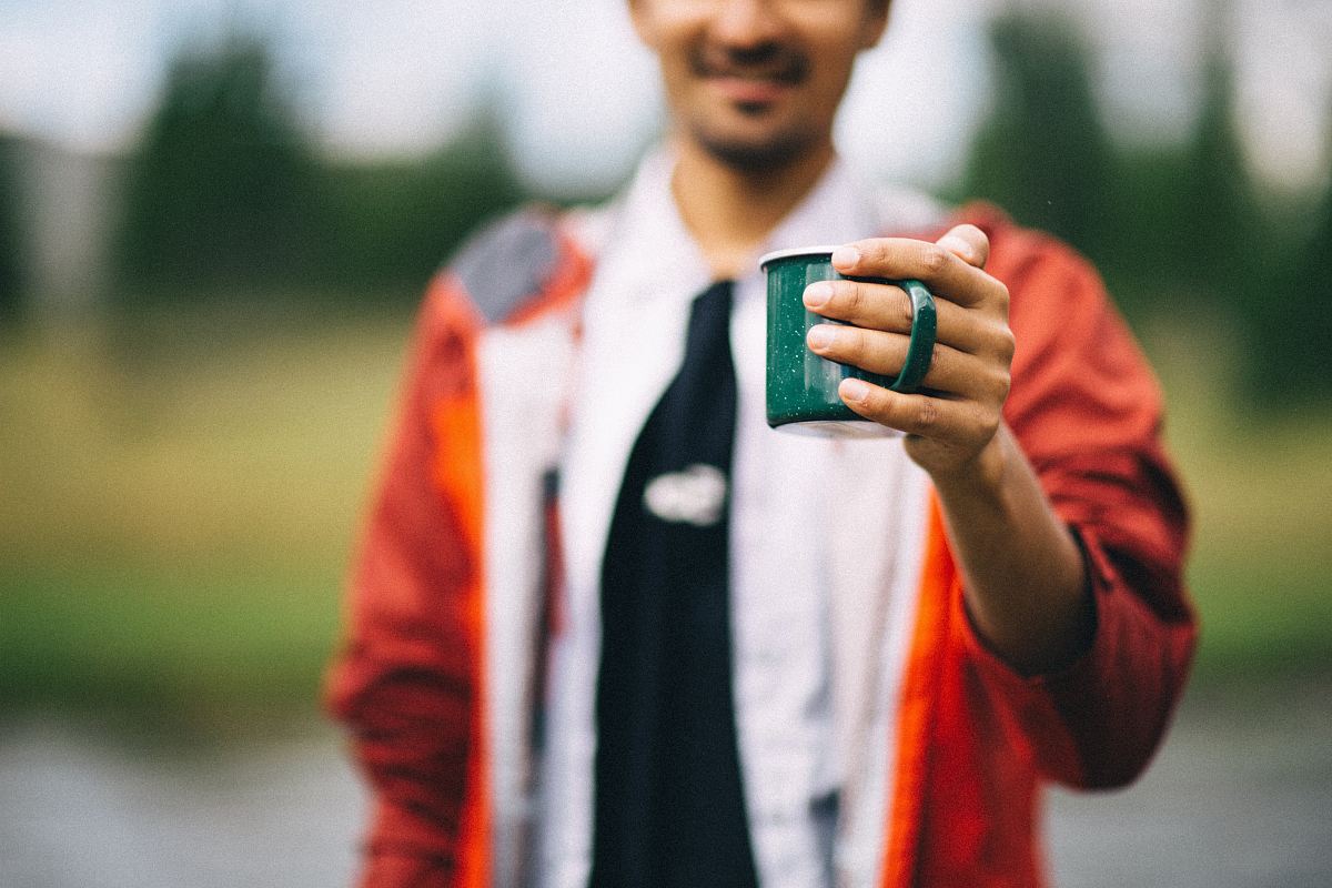 person holding mug in shallow focus