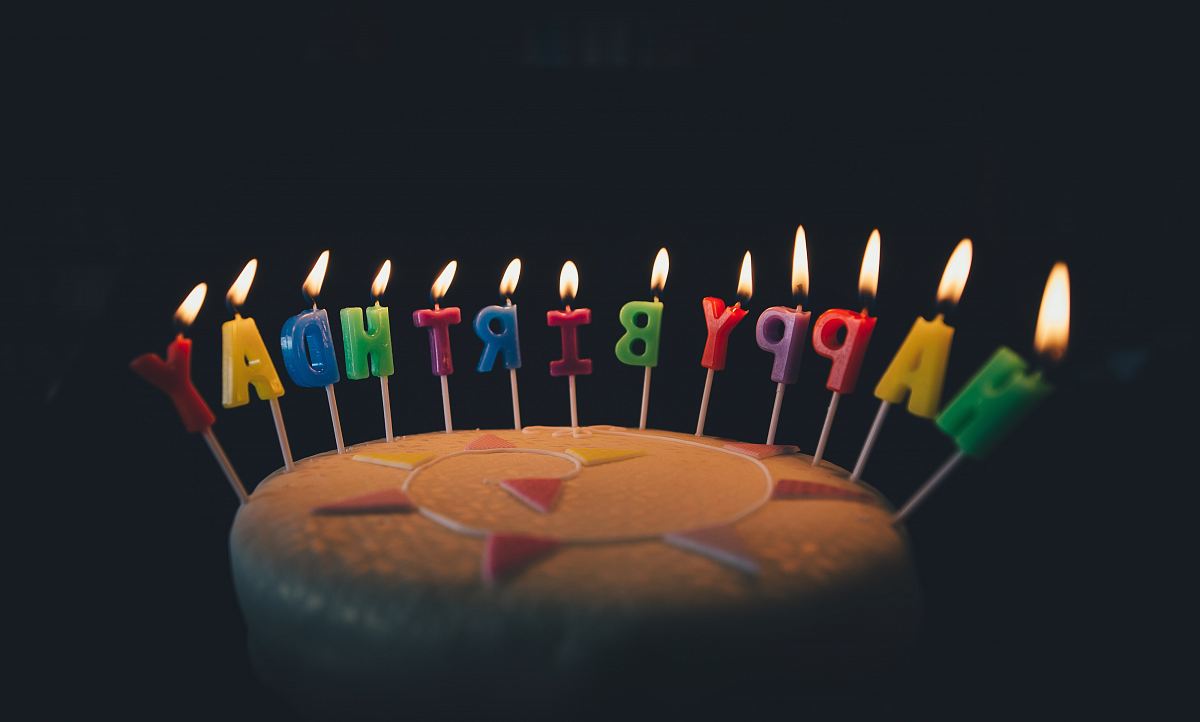 round fondant cake with happy birthday candle