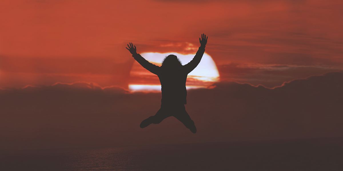 silhouette of person doing jumpshot during sunset