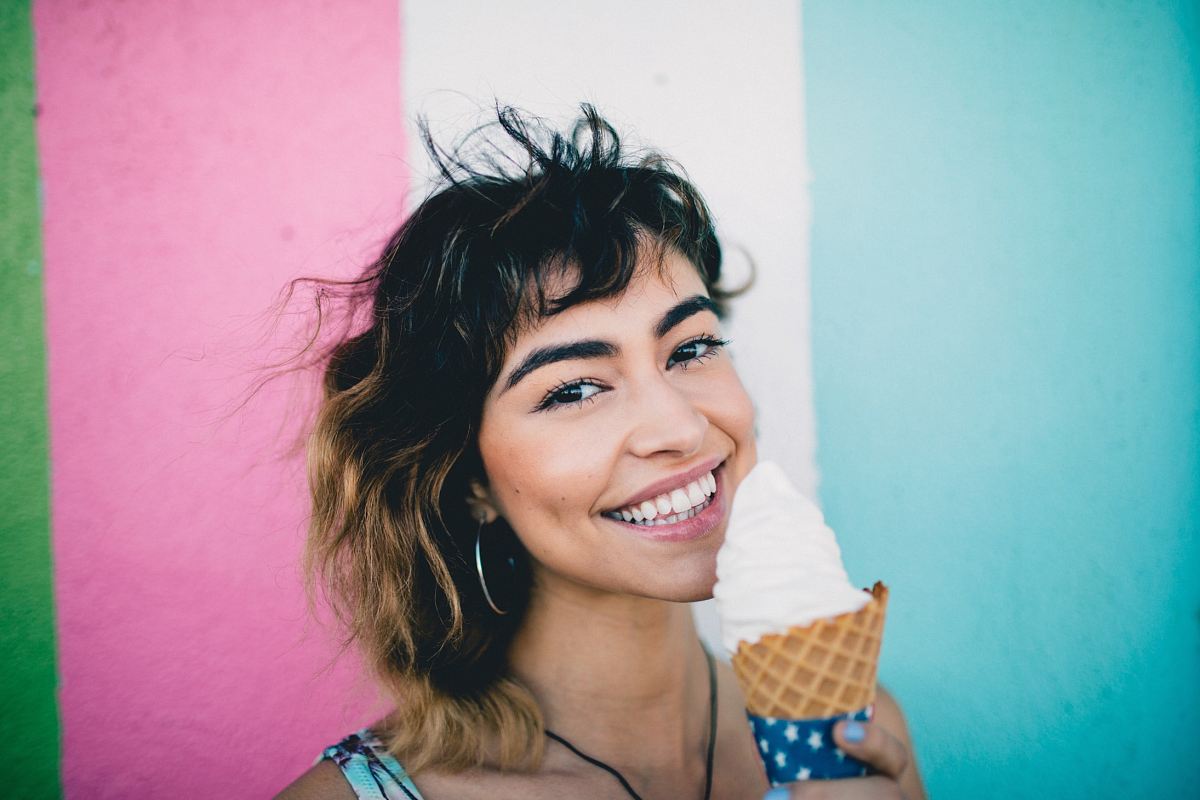 woman holding ice cream during daytime