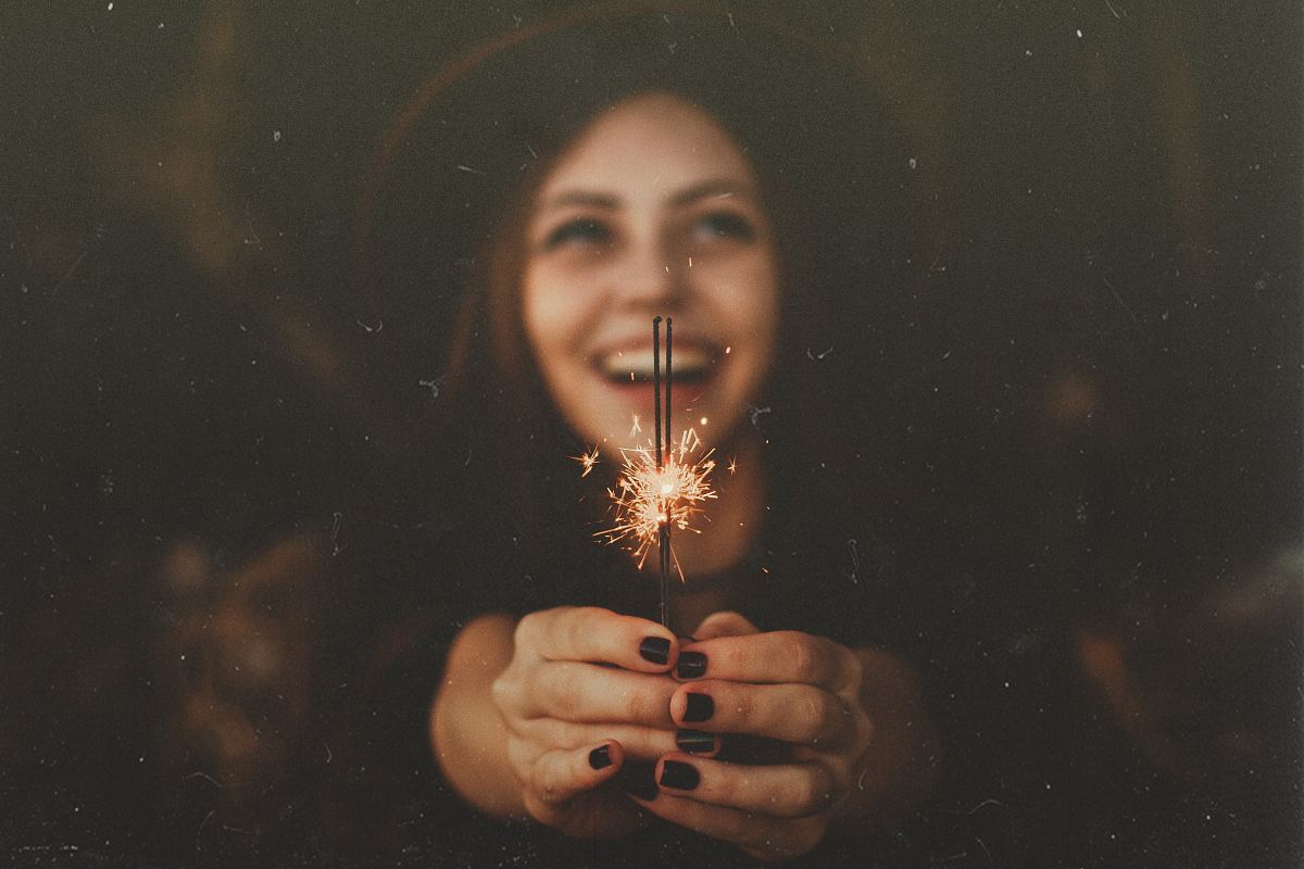 Woman Holding Sparklers While Smiling Image Free Photo