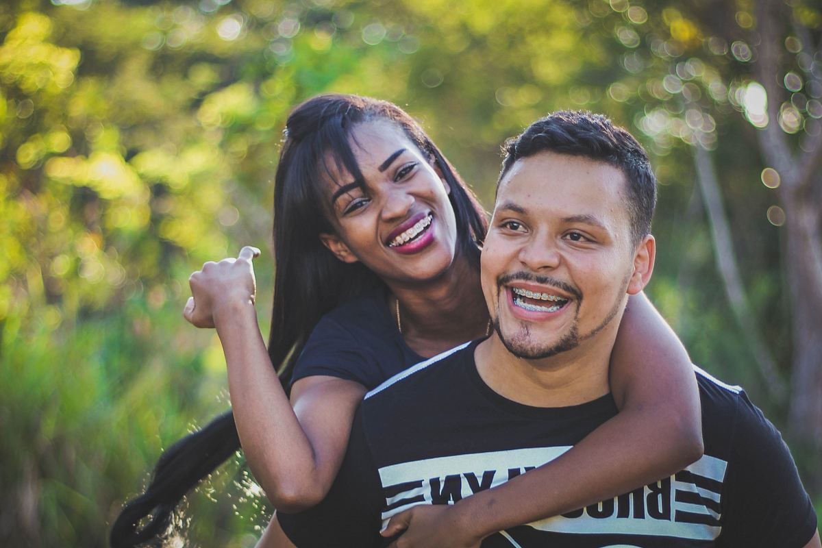 woman on top of man in black shirt