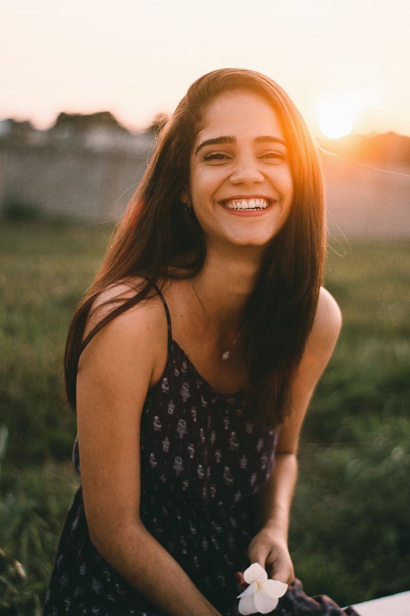 woman smiling in selective focus photography