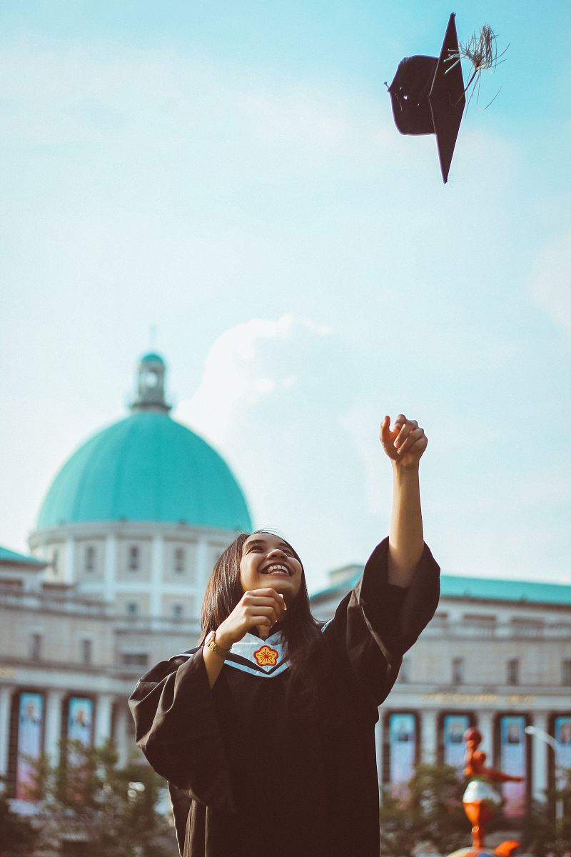 woman throwing her academic hat