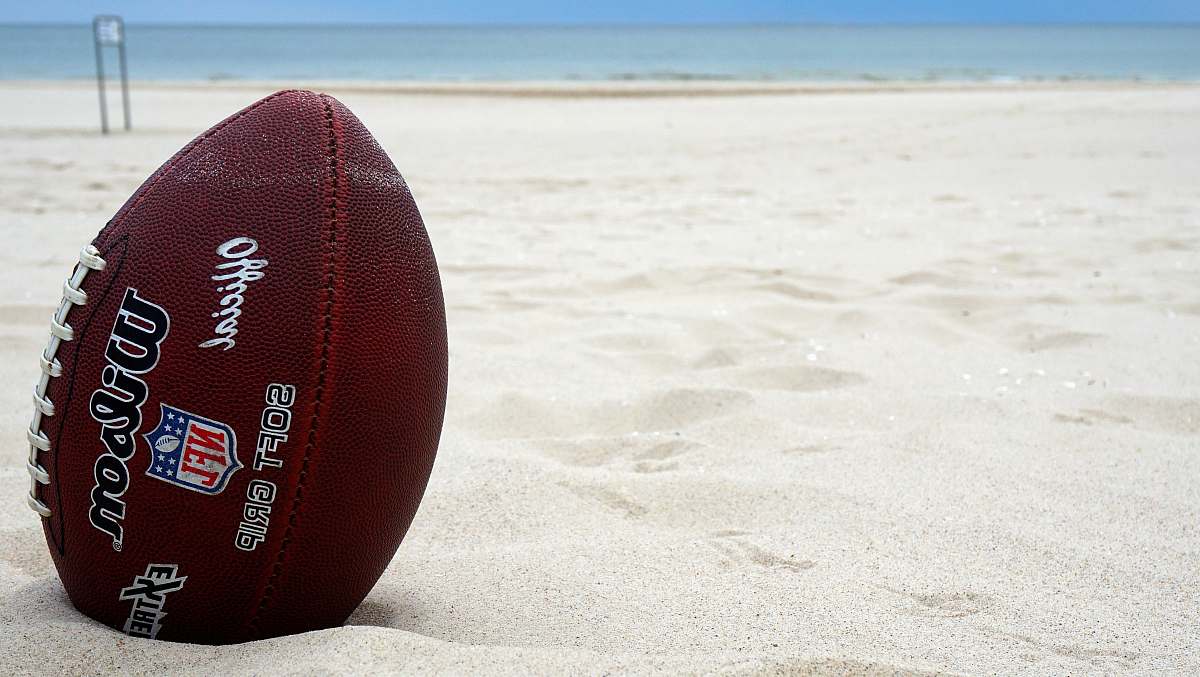 sports brown Wilson football on sand sport