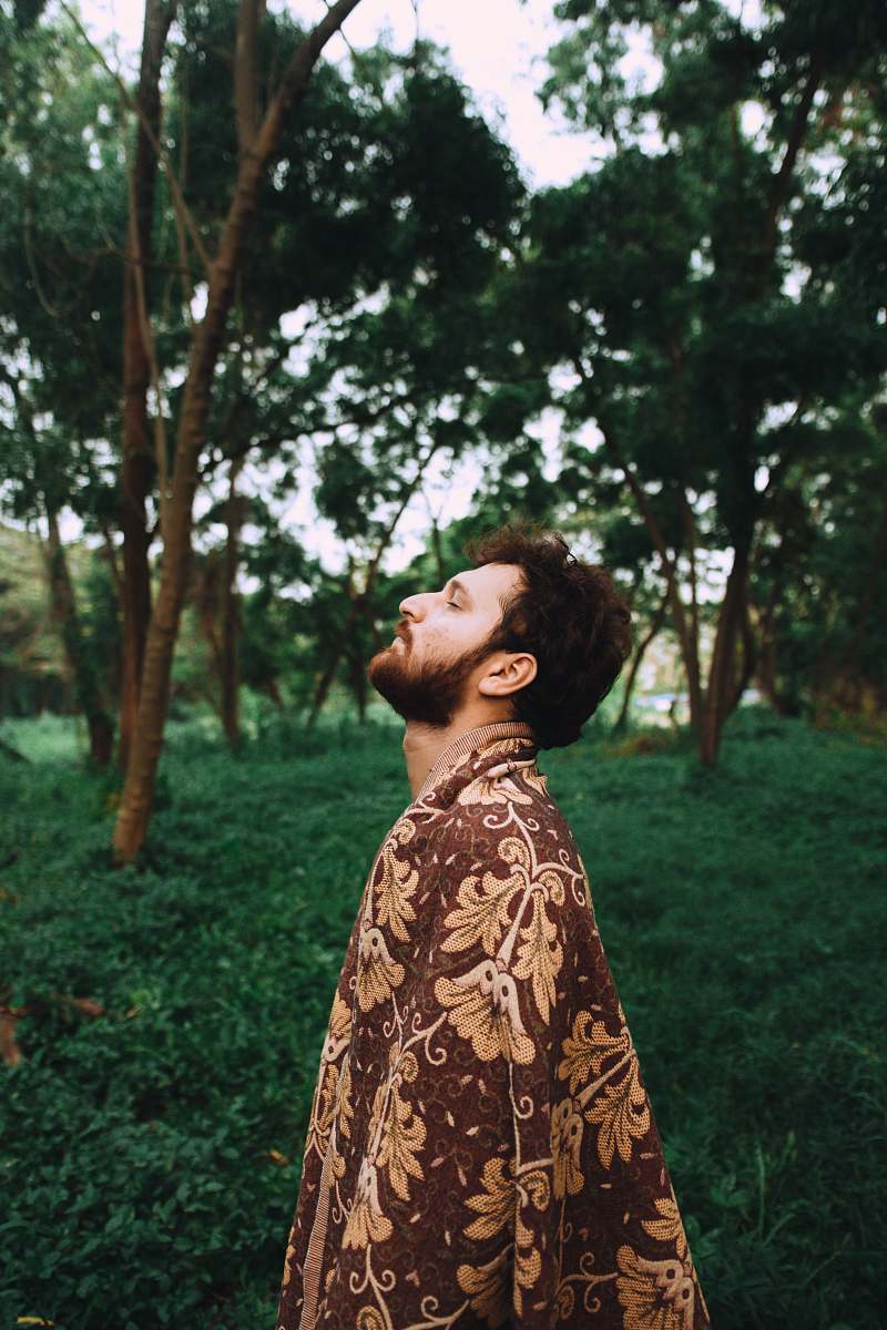 apparel man standing near tree fashion