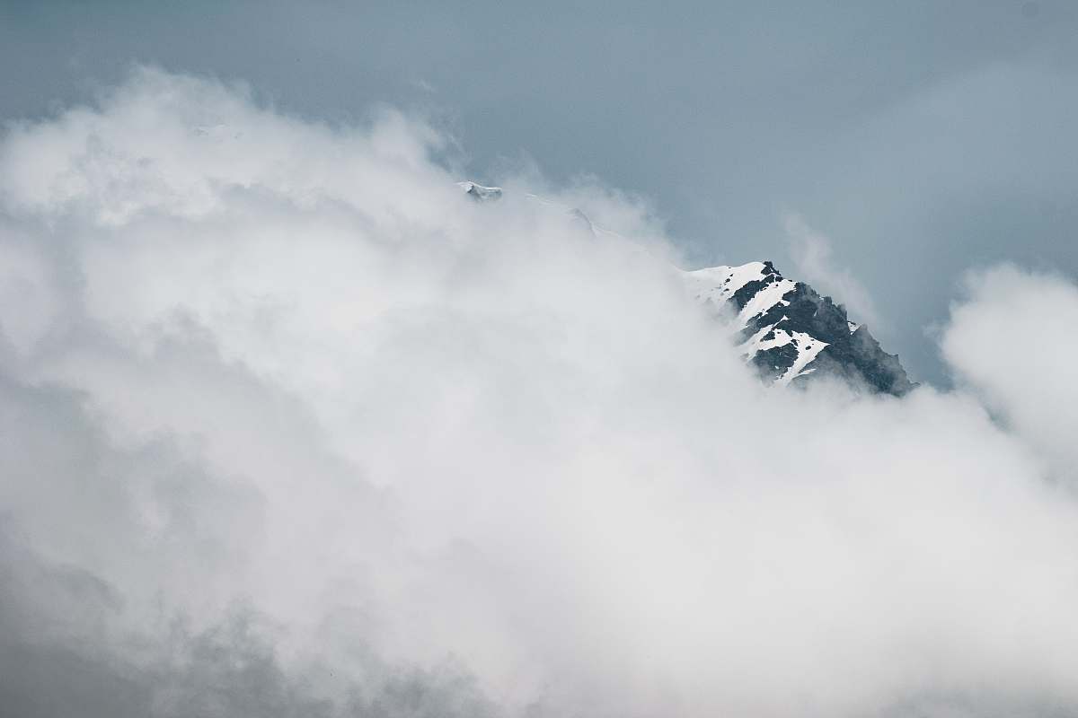 mountain landscape photography of snowy mountain covered white clouds cloud