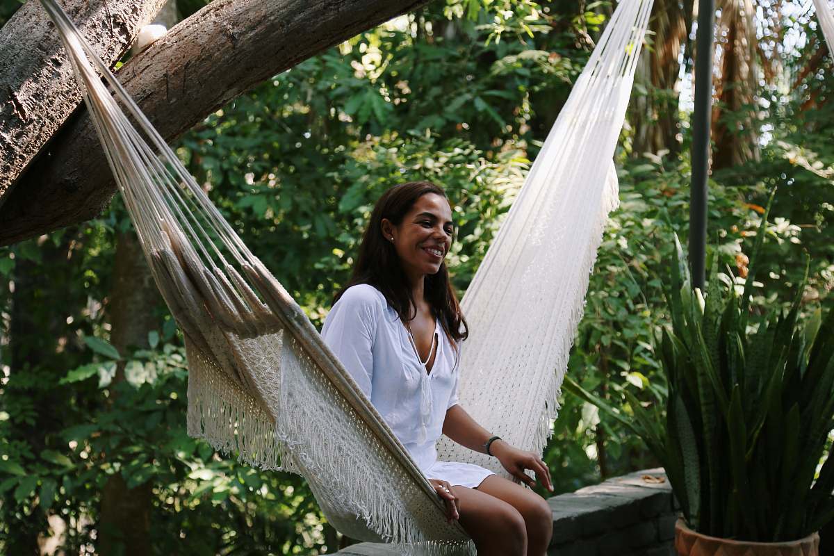 human woman sitting on hammock person