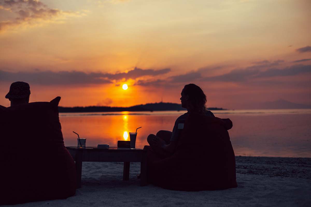 person silhouette of person sitting on chair during sunset people