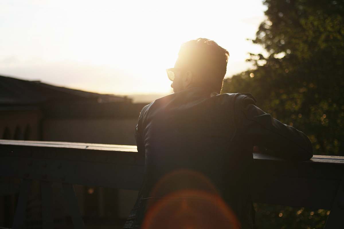 outdoors silhouette photography of person at ledge sun
