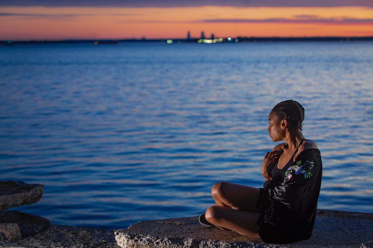human woman sitting near sea people