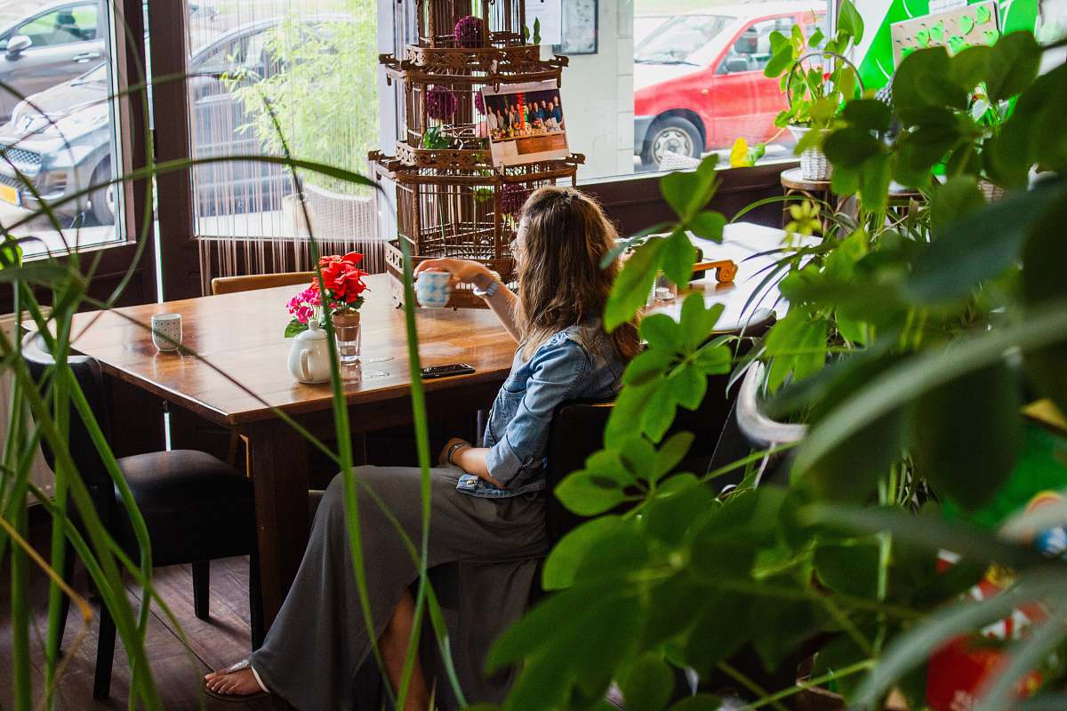 furniture woman sitting near wooden table chair