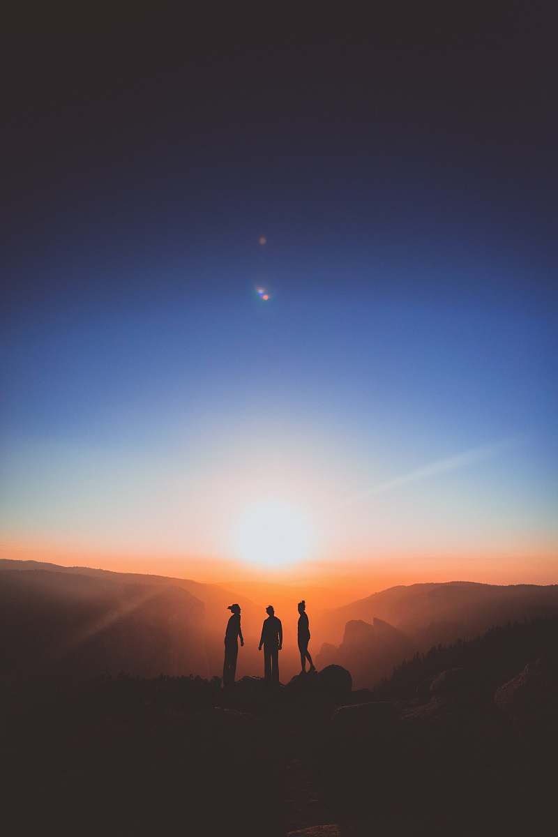 nature silhouette of three person standing on mountain outdoors