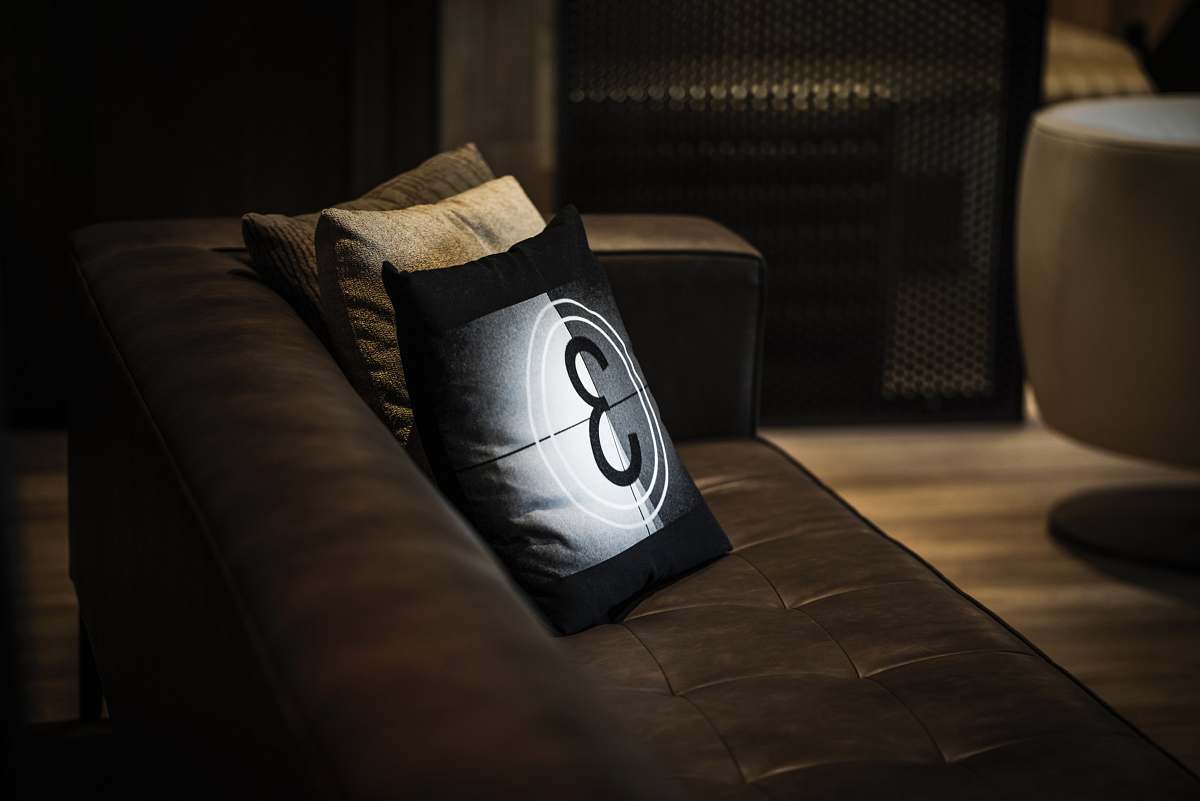 pillow three white, black, and brown throw pillows on sofa seat